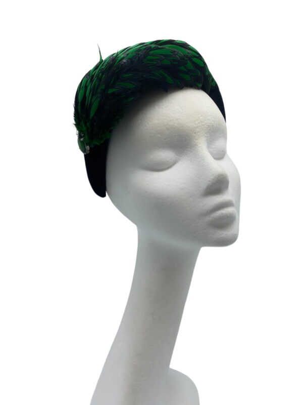 Stunning emerald green and black feather crown with little jewel detail to finish.